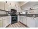 Bright kitchen boasts white cabinetry, granite countertops, and modern appliances at 8913 Welsh Way, Hudson, FL 34667