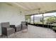 Relaxing screened lanai featuring brick flooring, comfortable seating, and a ceiling fan at 8913 Welsh Way, Hudson, FL 34667
