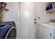 Well-equipped laundry room with a washer, dryer, and shelving for storage at 8913 Welsh Way, Hudson, FL 34667