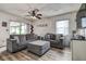 Cozy living room featuring comfortable seating, wood flooring, and natural light at 8913 Welsh Way, Hudson, FL 34667