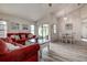 Open-concept living and dining area with hardwood floors and a sliding glass door at 8913 Welsh Way, Hudson, FL 34667