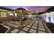 Outdoor living space with a stylish pergola, comfortable seating, and pavers perfect for entertaining at 895 Joan St, Dunedin, FL 34698