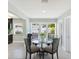 Bright dining area features a glass table, four chairs, and a view of the backyard at 895 Joan St, Dunedin, FL 34698