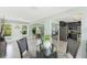 Open concept dining area connects to the living room and kitchen with tile floors and natural light at 895 Joan St, Dunedin, FL 34698