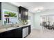 Modern kitchen featuring granite countertops, stainless steel appliances, and a view to the exterior at 895 Joan St, Dunedin, FL 34698