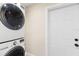 Convenient laundry room with a stacked washer and dryer, plus ample storage space at 895 Joan St, Dunedin, FL 34698