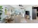 Bright living room with neutral tones, large window, and an open layout into the kitchen at 895 Joan St, Dunedin, FL 34698