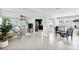 Open floor plan with living room, dining area, and kitchen with modern appliances and light tile flooring at 895 Joan St, Dunedin, FL 34698