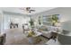Bright living room with neutral tones, tile flooring, and a large window with natural light at 895 Joan St, Dunedin, FL 34698