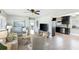 Inviting living room with neutral decor, ceiling fan, and an open concept to the kitchen at 895 Joan St, Dunedin, FL 34698