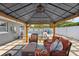 Comfortable outdoor living space with a covered patio, seating, and view of the pool area at 895 Joan St, Dunedin, FL 34698
