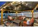 Cozy outdoor area with patio furniture, string lights, and access to the sparkling pool at 895 Joan St, Dunedin, FL 34698