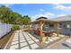 Outdoor patio with a pergola and pavers offers an ideal space for entertaining and relaxation at 895 Joan St, Dunedin, FL 34698