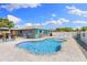 Backyard view of private pool with brick pavers and lush landscaping, offering a relaxing outdoor oasis at 895 Joan St, Dunedin, FL 34698