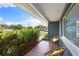 Cozy porch with comfortable seating and views of lush greenery and a quiet street at 895 Joan St, Dunedin, FL 34698