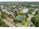 Beautiful aerial view of community, lake, tennis court, playground, and surrounding homes and lush landscaping at 9220 Dayflower Dr, Tampa, FL 33647