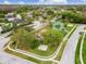 Community aerial view features tennis and playground, emphasizing recreational amenities and residential layout at 9220 Dayflower Dr, Tampa, FL 33647