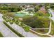 Aerial view of community featuring tennis courts, playground, and tree-lined streets at 9220 Dayflower Dr, Tampa, FL 33647