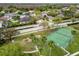 Community with tennis court and playground surrounded by tree-lined streets at 9220 Dayflower Dr, Tampa, FL 33647