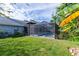 A large grassy yard is adjacent to the pool and patio, perfect for entertaining at 9220 Dayflower Dr, Tampa, FL 33647