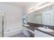 Bright bathroom with dual sinks, granite countertops, soaking tub, and a separate glass shower at 9220 Dayflower Dr, Tampa, FL 33647