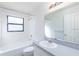 Bathroom featuring a shower and tub combination, vanity, and large mirror at 9220 Dayflower Dr, Tampa, FL 33647