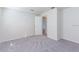 Empty bedroom with neutral carpet, white trim, and natural lighting at 9220 Dayflower Dr, Tampa, FL 33647
