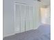 Bedroom with carpet floor and large closet doors at 9220 Dayflower Dr, Tampa, FL 33647