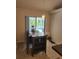 Bright dining area with dark table and chairs with a view of the private pool at 9220 Dayflower Dr, Tampa, FL 33647