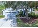 Inviting single-story home showcasing a well-maintained lawn and two car garage at 9220 Dayflower Dr, Tampa, FL 33647