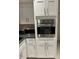 Modern kitchen showcasing stainless steel oven, microwave and white shaker cabinets at 9220 Dayflower Dr, Tampa, FL 33647