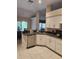 Modern kitchen with stainless steel dishwasher, white cabinets and a kitchen sink overlooking the dining area at 9220 Dayflower Dr, Tampa, FL 33647