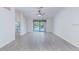 Bright living room with wood floors, ceiling fan, and sliding glass doors to the pool at 9220 Dayflower Dr, Tampa, FL 33647