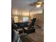 Open-concept living room featuring a sectional sofa, columns, and a ceiling fan at 9220 Dayflower Dr, Tampa, FL 33647