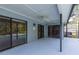 Screened patio with ceiling fan and tile overlooking the backyard and pool area at 9220 Dayflower Dr, Tampa, FL 33647