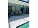 Covered patio boasts a dining area and ceiling fan, perfect for outdoor entertaining near the pool at 9220 Dayflower Dr, Tampa, FL 33647