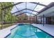 Private screened pool with jacuzzi tub and backyard, perfect for entertaining and relaxation at 9220 Dayflower Dr, Tampa, FL 33647