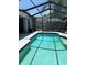Sparkling pool with a screened enclosure and lush backyard offers a private and refreshing escape at 9220 Dayflower Dr, Tampa, FL 33647
