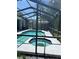 Inviting screened-in pool and spa surrounded by a spacious patio at 9220 Dayflower Dr, Tampa, FL 33647