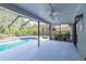 Beautiful pool with ample seating space with jacuzzi tub and landscaped backyard for relaxation at 9220 Dayflower Dr, Tampa, FL 33647