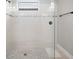 Clean and modern walk-in shower with white tile, glass enclosure, and black hardware at 923 Whimbrel Run, Bradenton, FL 34212
