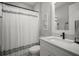 Modern bathroom with clean lines, white vanity, and a shower with a stylish curtain at 923 Whimbrel Run, Bradenton, FL 34212
