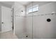 Modern walk-in shower with white tile, glass enclosure, and black hardware accents at 923 Whimbrel Run, Bradenton, FL 34212