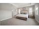 Bright, carpeted bedroom with neutral tones, tray ceiling, and plantation shutters at 923 Whimbrel Run, Bradenton, FL 34212