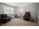 Bright bedroom with neutral carpet and walls, and a large window with blinds at 923 Whimbrel Run, Bradenton, FL 34212