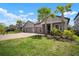 Beautiful single-Gathering home with a two-car garage, lush lawn, and lovely landscaping including palm trees at 923 Whimbrel Run, Bradenton, FL 34212