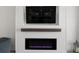 Close-up of a modern fireplace with shiplap surround and dark wood mantle at 923 Whimbrel Run, Bradenton, FL 34212