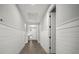 Hallway with wood-look floors, white wainscoting, and a trey ceiling detail at 923 Whimbrel Run, Bradenton, FL 34212