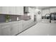 White kitchen cabinets and quartz countertops, creating a bright, modern space with an island cooktop at 923 Whimbrel Run, Bradenton, FL 34212