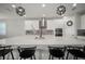 Open concept kitchen with quartz countertops, stainless steel appliances, and a large island with seating at 923 Whimbrel Run, Bradenton, FL 34212
